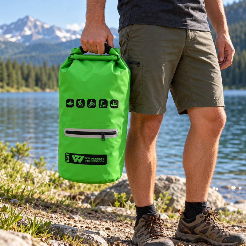 Load image into Gallery viewer, Wilderness Technology PVC Dry Bag 20L with zip pocket in Green, in use outdoors

