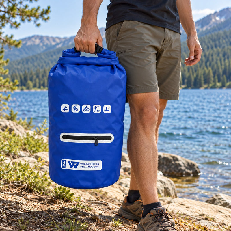 Load image into Gallery viewer, Wilderness Technology PVC Dry Bag 30L with zip pocket in Dark Blue, in use outdoors
