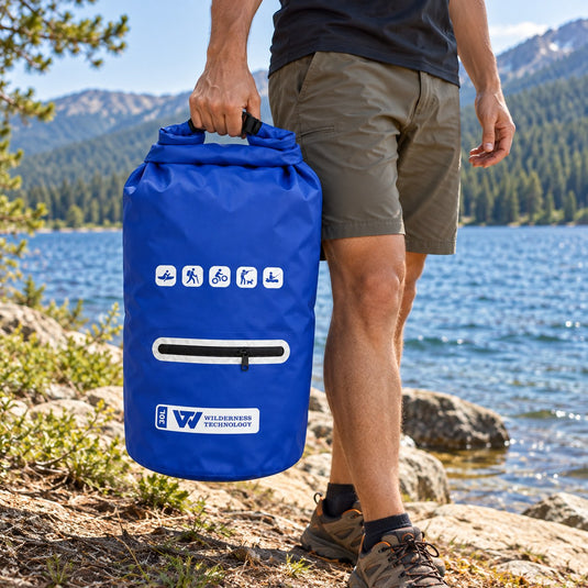 Wilderness Technology PVC Dry Bag 30L with zip pocket in Dark Blue, in use outdoors