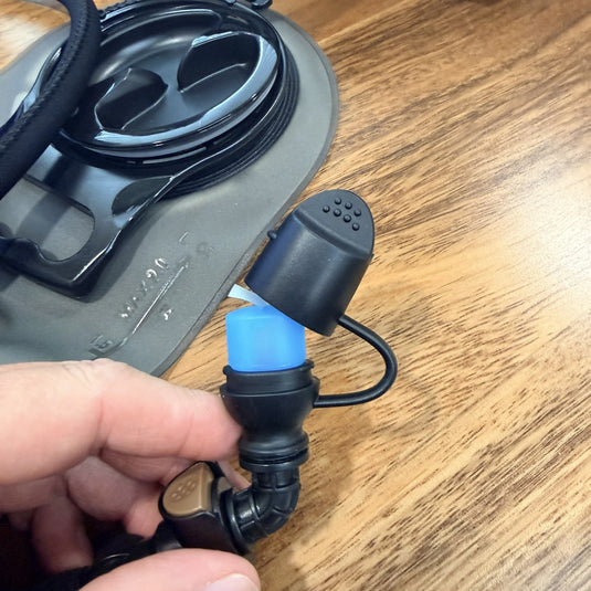 Hydration bladder bite valve with dust cap open