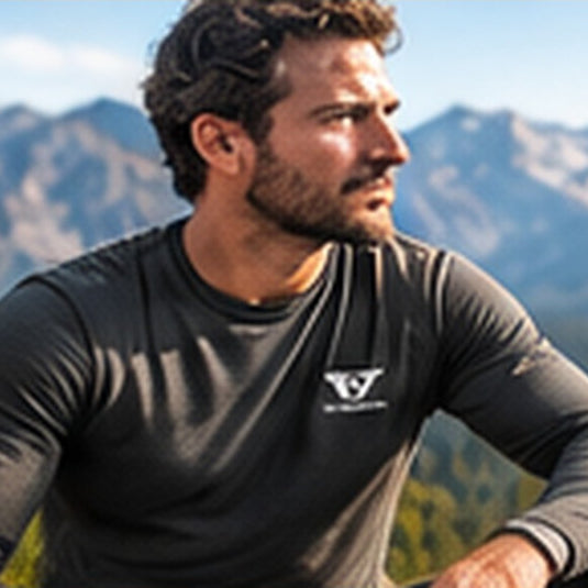 Man wearing the charcoal merino crew top in the mountains